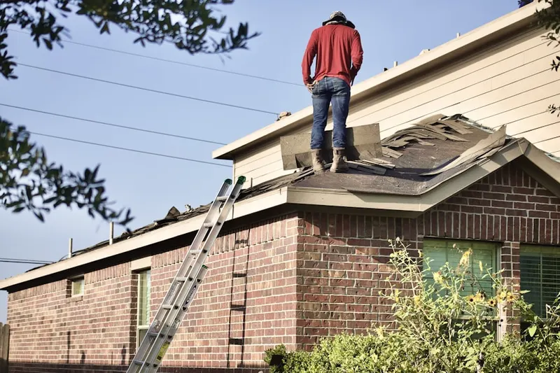 Professional roofer working on a residential roof in Lake Bay